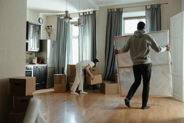 two people moving furniture