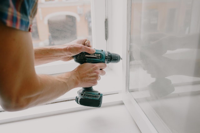  fixing a window with an electric drill