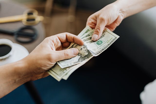 person handing another person money