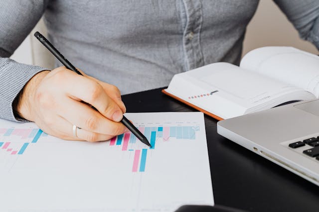person looking at graphs on paper