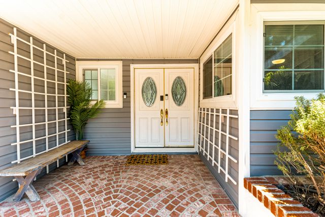 residential porch with double doors and brick flooring