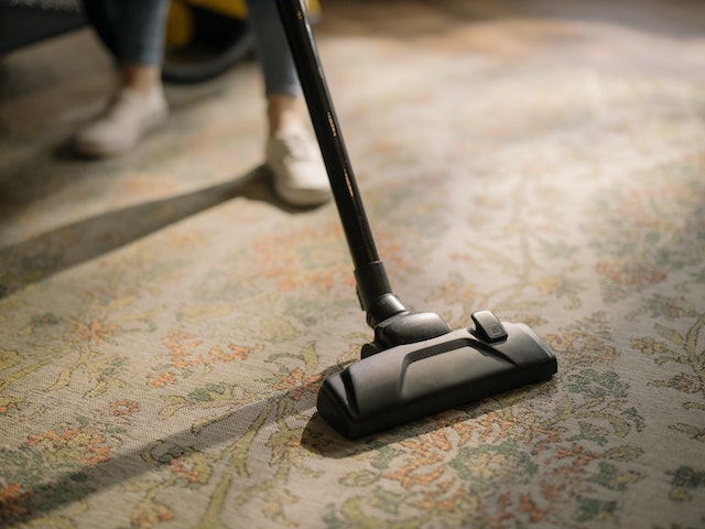 someone vacuuming a carpet